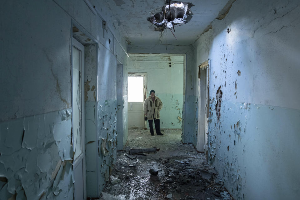 Valentyna Mozgova, 55, lab medic stands inside a hospital which was damaged by Russian shelling in Krasnohorivka, Ukraine, Sunday, Feb. 19, 2023. (AP Photo/Evgeniy Maloletka)