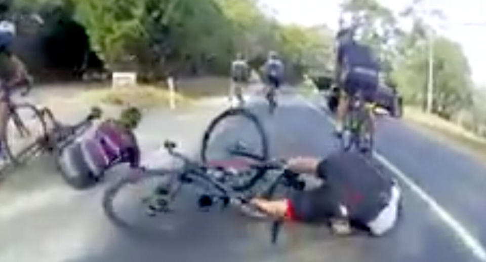 A number of cyclists are seen crashed on the ground as the ute turns right after braking. Source: Facebook