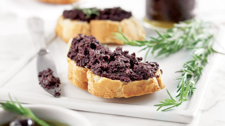 olive tapenade on sliced baguette 