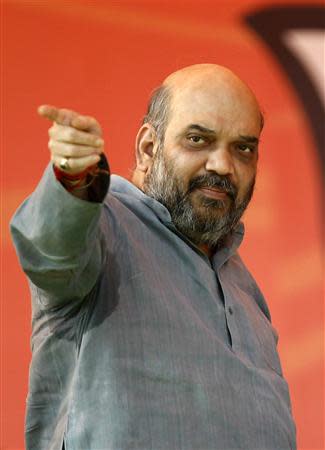 Amit Shah, a leader of India's main opposition Bharatiya Janata Party (BJP) gestures towards his party supporters before a rally addressed by Hindu nationalist Narendra Modi, prime ministerial candidate for BJP in the northern Indian city of Agra November 21, 2013. REUTERS/Anindito Mukherjee