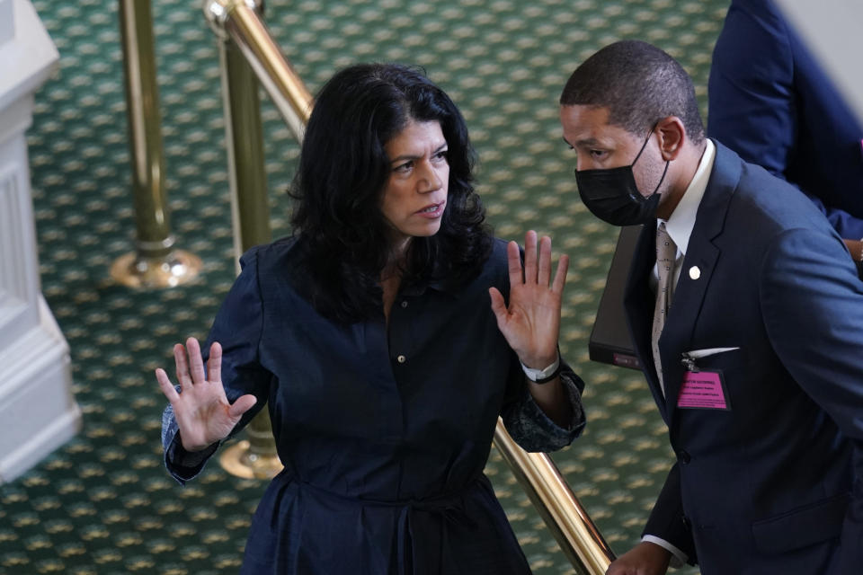 Texas state Sen. Carol Alvarado, D-Houston, talks with staff as she prepares to filibuster Senate Bill 1, a voting bill, at the Texas Capitol, Wednesday, Aug. 11, 2021, in Austin, Texas. (AP Photo/Eric Gay)