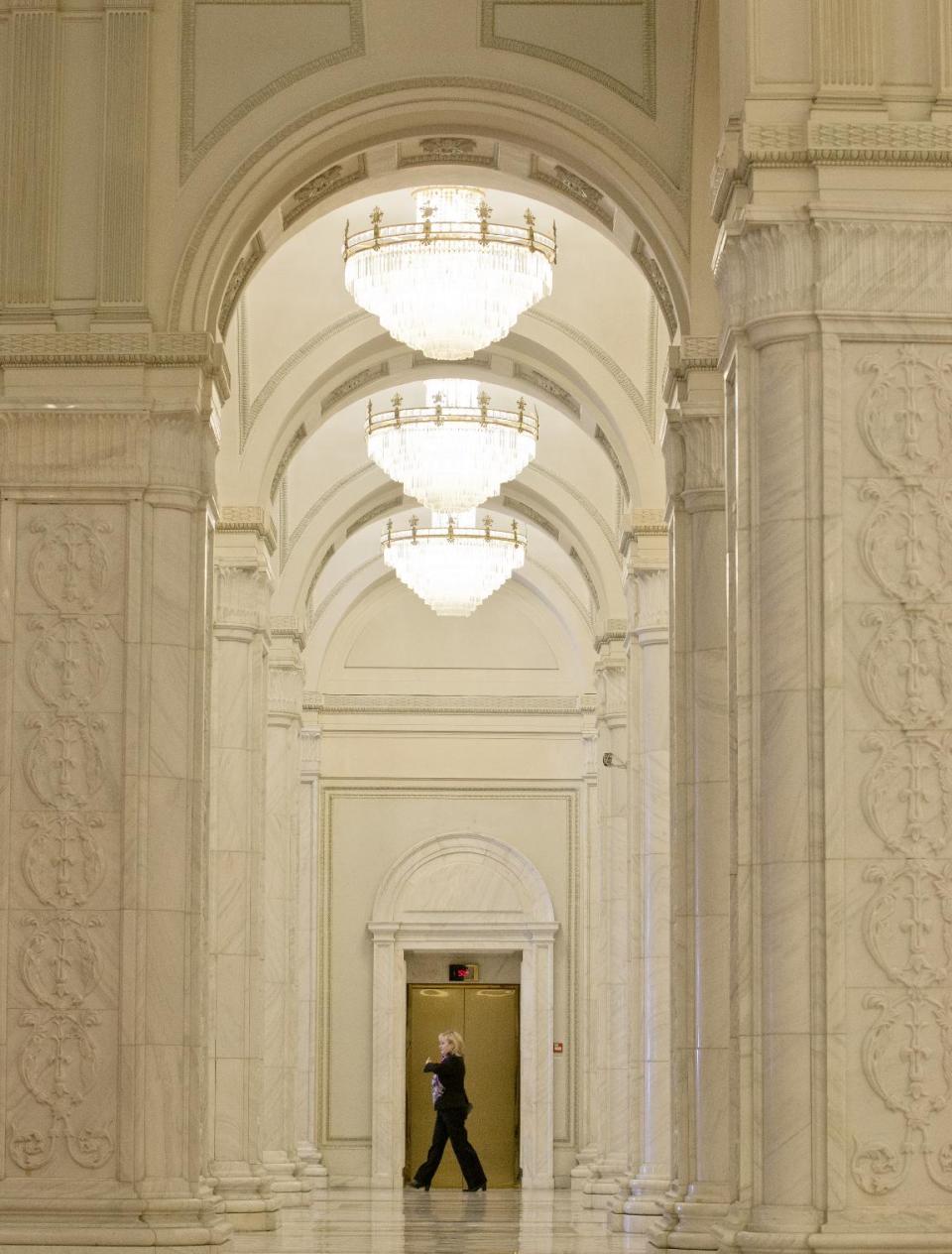 A picture taken on Dec. 12, 2012, shows a woman walking inside the Parliament Palace in Bucharest, Romania. Twenty-three years after communism collapsed, the Palace of the Parliament, a gargantuan Stalinist symbol and the most concrete legacy of ex-dictator Nicolae Ceausescu, has emerged as an unlikely pillar of Romania's nascent democracy. And while it remains one of the most controversial projects of Ceausescu's 25-year rule, albeit one that has gradually found a place in the nation's psyche, it's also now a tourist attraction, visited by tens of thousands of Romanians and foreigners every year. (AP Photo/Vadim Ghirda)