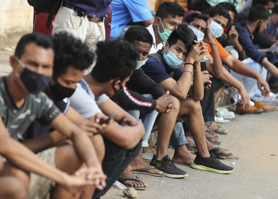 Stranded migrant workers wait to board buses before taking a special train to their destination during extended lockdown to curb the spread of new coronavirus, in Bangalore, India, Monday, May 18, 2020. India has recorded its biggest single-day surge in new cases of coronavirus. The surge in infections comes a day after the federal government extended a nationwide lockdown to May 31 but eased some restrictions to restore economic activity and gave states more control in deciding the nature of the lockdown. (AP Photo/Aijaz Rahi)