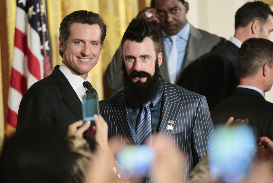 FILE - Then-California Lt. Gov Gavin Newsom, left, poses with San Francisco Giants baseball pitcher pitcher Brian Wilson at the White House during a ceremony in Washington on July 25, 2011. California Democratic Gov. Gavin Newsom is headed to Washington this week. The East coast swing is anchored to an award Newsom will receive Wednesday, July 13, 2022, from an education group recognizing, among other things, that California is on track to establish universal pre-K classes for all 4-year-olds by 2025. (AP Photo/Pablo Martinez Monsivais, File)