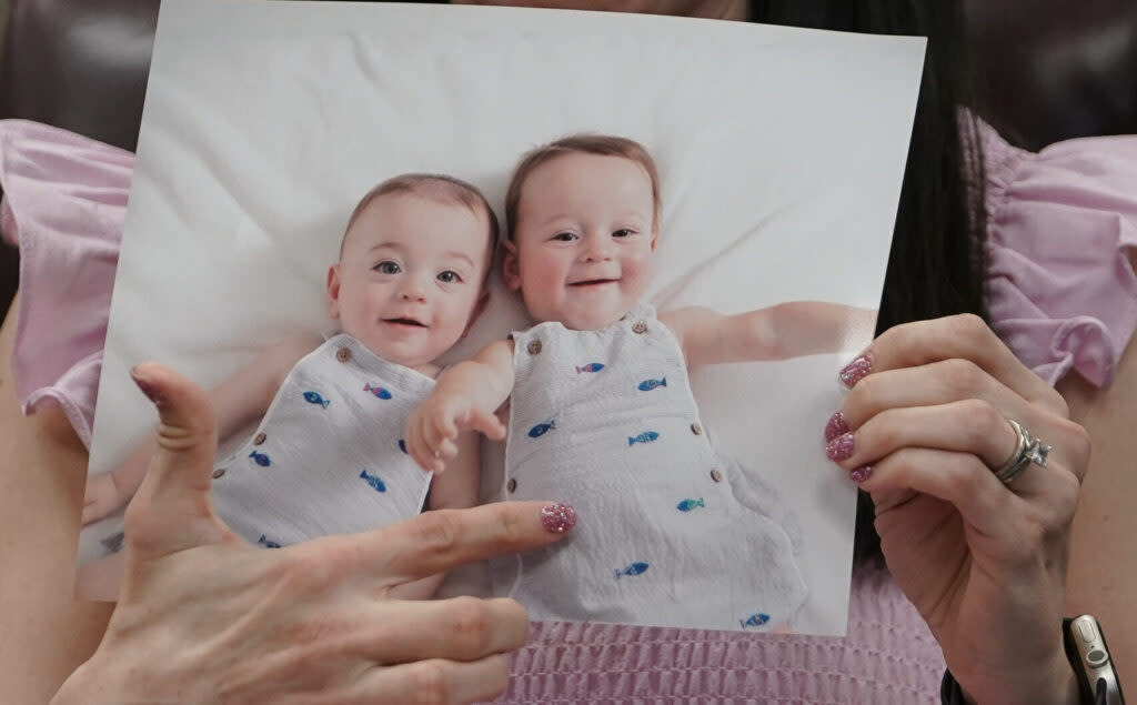 In vitro fertilization patient Julie Cohen holds up a photo of her children at a roundtable discussion with patients and health professionals on Feb. 27, 2024, in Birmingham, Alabama. (Photo by Elijah Nouvelage/Getty Images)