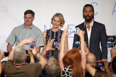 Journalists take pictures with their mobile phone as cast members Naomi Watts (C) and Matthew McConaughey (R), and director Gus Van Sant (L) arrive to attend a news conference for the film "The Sea of Trees" in competition at the 68th Cannes Film Festival in Cannes, southern France, May 16, 2015. REUTERS/Benoit Tessier