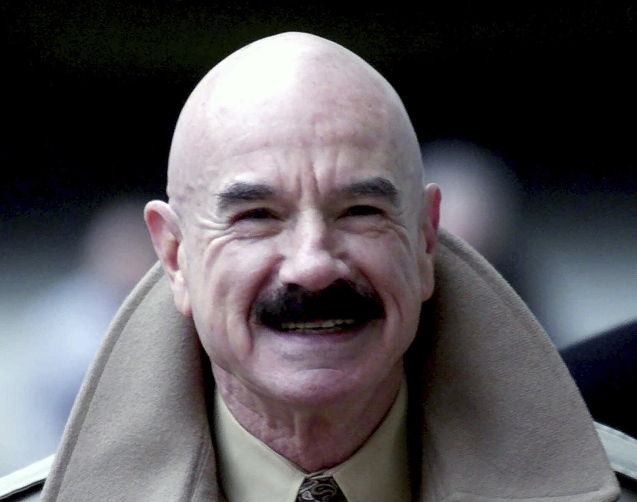 FILE - This Jan. 16, 2001, file photo shows G. Gordon Liddy, a Watergate conspirator, arriving at Baltimore's federal courthouse. Liddy, a mastermind of the Watergate burglary and a radio talk show host after emerging from prison, has died at age 90. His son, Thomas Liddy, confirmed the death Tuesday, March 30, 2021, but did not reveal the cause. (AP Photo/Roberto Borea, File)