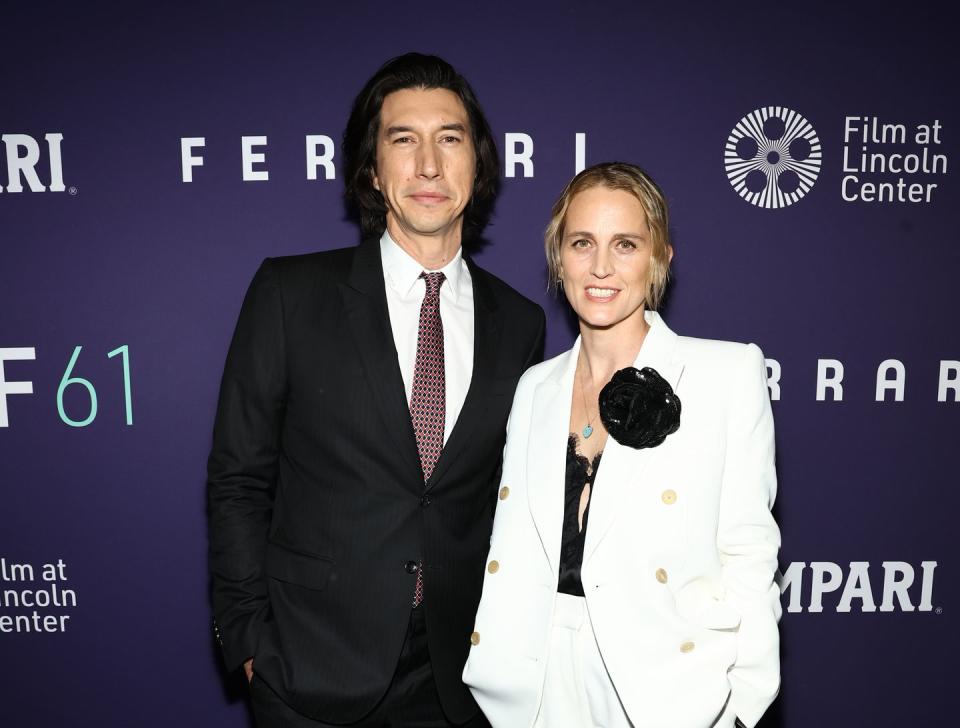 adam ferrari and wife joanne tucker smiling for a red carpet photo at a film premiere