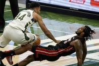 Miami Heat's Trevor Ariza fouls Milwaukee Bucks' Giannis Antetokounmpo during the first half of an NBA basketball game Saturday, May 15, 2021, in Milwaukee. (AP Photo/Morry Gash)