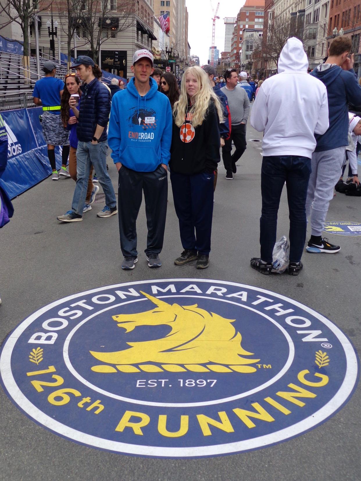 Gary Pate of Alliance and his daughter Chrystina pose at the finish line after he finished running the 126th Boston Marathon.