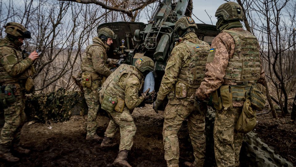 Ukrainian servicemen load a shell into a Msta-B howitzer to fire towards Russian positions. - Dimitar Dilkoff/AFP/Getty Images