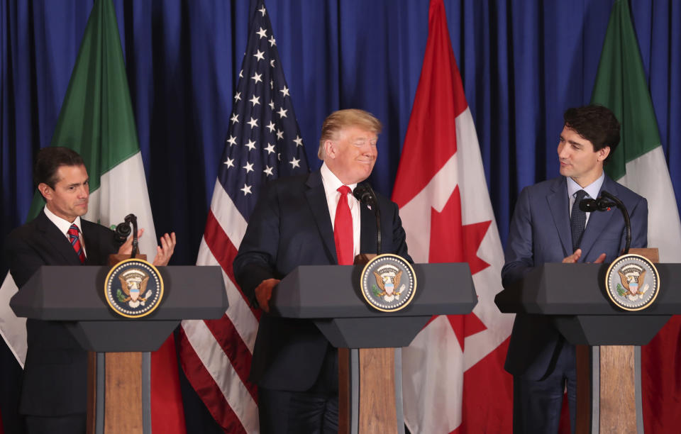 Flanked by Mexico's President Enrique Pena Nieto, left, and Canada's Prime Minister Justin Trudeau, President Donald Trump smiles during a signing ceremony of their trilateral trade agreement, on the sidelines of the Group of 20 summit in Buenos Aires, Argentina, on Friday, Nov. 30, 2018. The United States-Mexico-Canada Agreement, or USMCA as Trump refers to it, must still be approved by lawmakers in all three countries. (AP Photo/Martin Mejia)