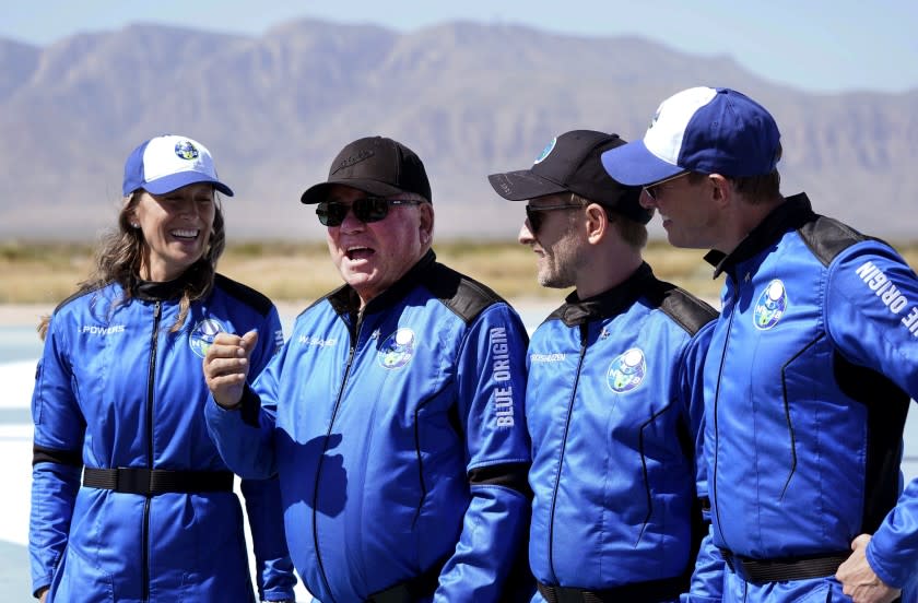 William Shatner, center right, speaks as Audrey Powers, left, Chris Boshuizen, center right, and Glen de Vries all look on during a media availability at the Blue Origin spaceport near Van Horn, Texas, Wednesday, Oct. 13, 2021. The "Star Trek" actor and the three fellow passengers hurtled to an altitude of 66.5 miles (107 kilometers) over the West Texas desert in the fully automated capsule, then safely parachuted back to Earth in a flight that lasted just over 10 minutes.(AP Photo/LM Otero)