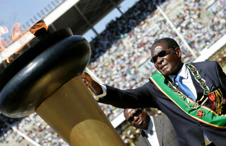 FILE PHOTO - Zimbabwe President Robert Mugabe lights the independence flame during the 29th Independence Celebrations at the National Stadium in Harare, Zimbabwe April 18, 2009. REUTERS/Philimon Bulawayo/File Photo