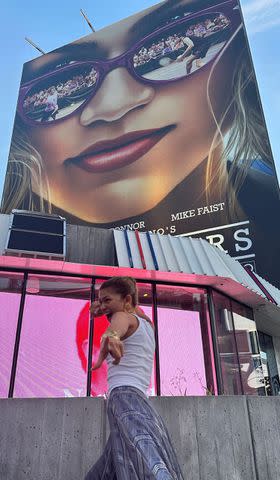 <p>Zendaya/Instagram</p> Zendaya posing in front of a 'Challengers' billboard
