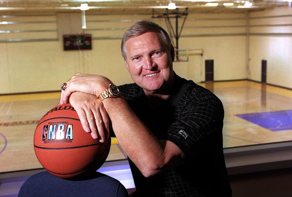 Jerry West holding a basketball