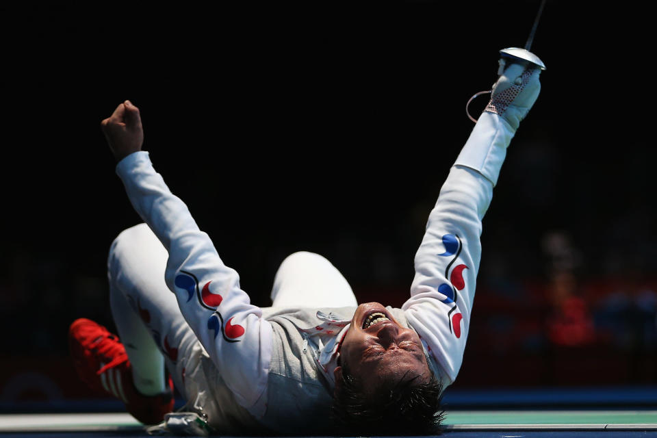 LONDON, ENGLAND - JULY 31: Byungchul Choi of Korea celebrates winning his match against Jianfei Ma of China during the quaterfinals of the Men's Foil Individual on Day 4 of the London 2012 Olympic Games at ExCeL on July 31, 2012 in London, England. (Photo by Hannah Johnston/Getty Images)