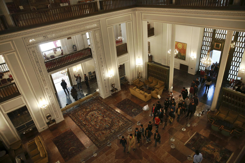 In this Tuesday, Jan. 15, 2019 photo, a group of Iranian schoolboys visit Niavaran Palace, now a museum, that was the primary and last residence of late Shah Mohammad Reza Pahlavi and his family prior to leaving Iran for exile during the 1979 Islamic Revolution, in northern Tehran, Iran. Niavaran Palace was a palatial estate nestled against the Alborz Mountains that no Iranian ever dreamed of visiting. Today, it costs about $1 to enter. (AP Photo/Vahid Salemi)