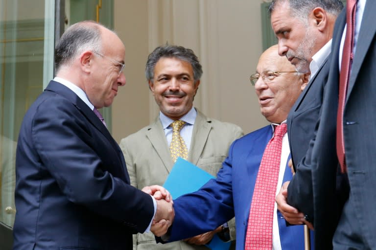 French Interior Minister Bernard Cazeneuve (L) shakes hands with Paris' Mosque Rector Dalil Boubakeur following a meeting with representatives of the Muslim community on August 29, 2016 in Paris