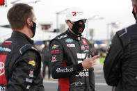 Kyle Busch, center, waits for the start of a NASCAR Truck Series auto race at Charlotte Motor Speedway Tuesday, May 26, 2020 in Concord, N.C. (AP Photo/Gerry Broome)