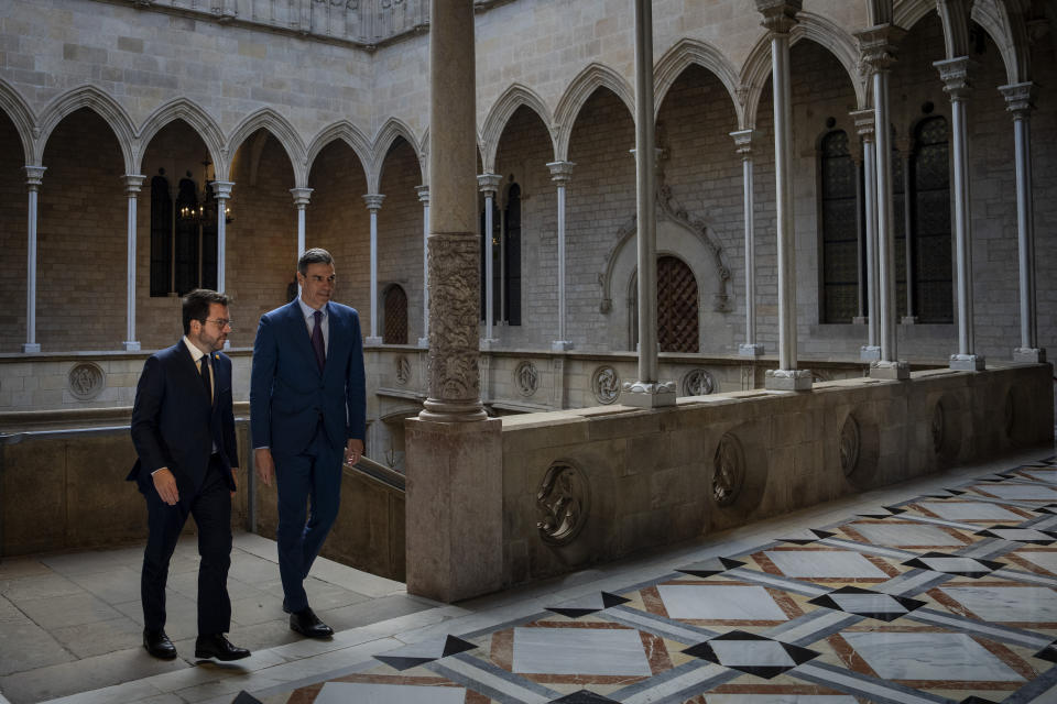 Spanish Prime Minister Pedro Sanchez, right, walks with Catalonia's President Pere Aragones during a meeting in Barcelona, Spain, Thursday, Dec. 21, 2023. Sanchez and Aragones meet in the first encounter since an amnesty for Catalan separatists was announced earlier this year. (AP Photo/Emilio Morenatti)