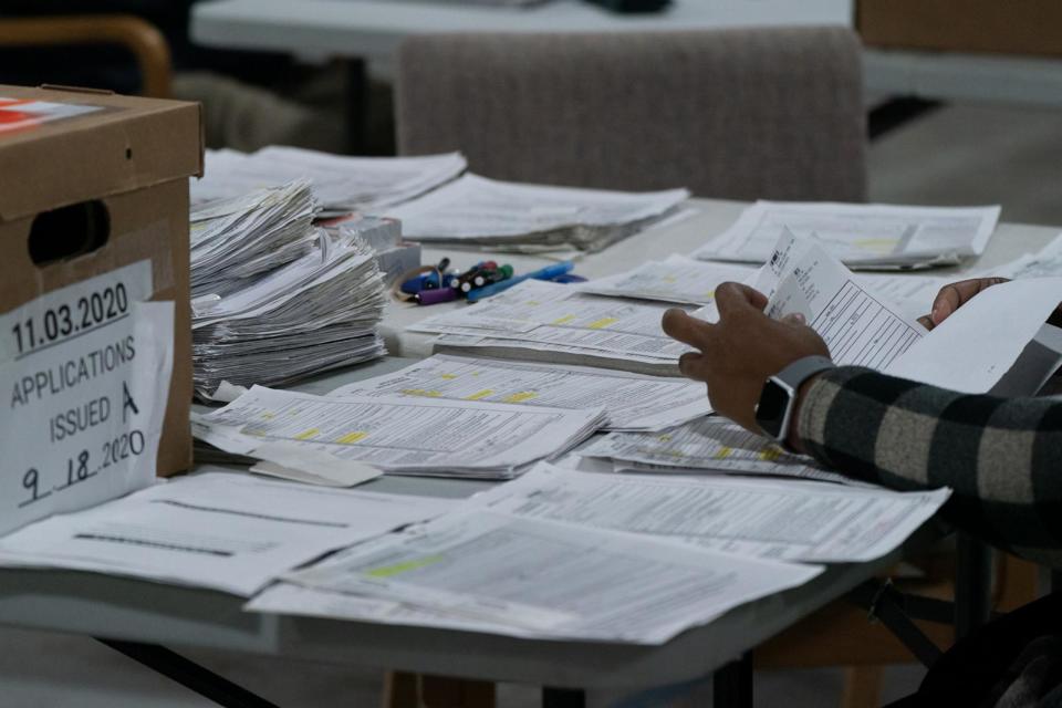 PHOTO: In this Nov. 7, 2020 file photo election personnel sort absentee  ballot applications for storage at the Gwinnett County Board of Voter Registrations and Elections offices in Lawrenceville, Ga. (Elijah Nouvelage/Getty Images, FILE)