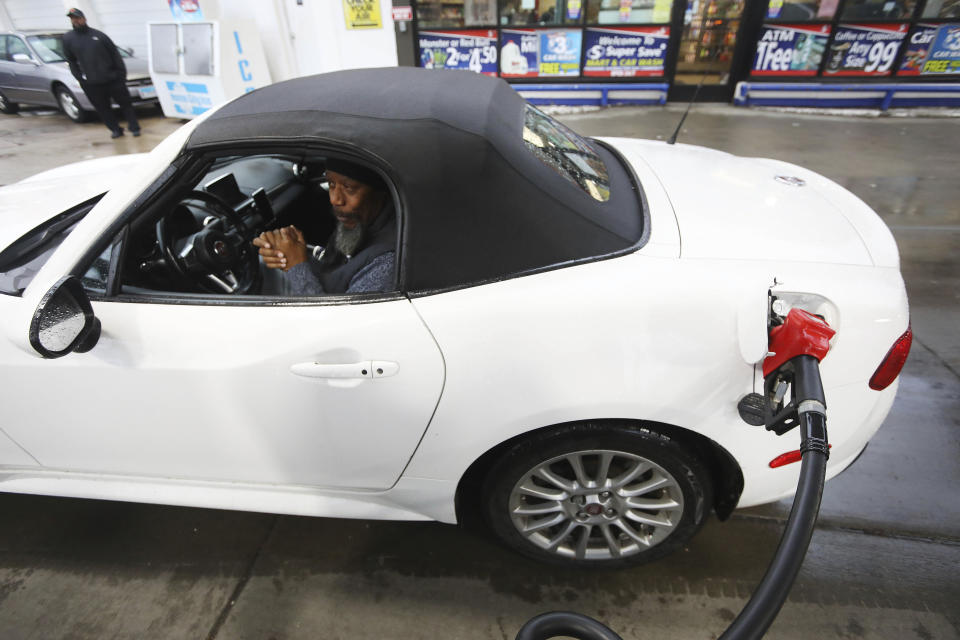 Lewis Ball of Lincolnwood is excited to receive free gas donated by Willie Wilson at the Mobil Gas Station along Green Bay Road on Thursday, March 24, 2022, in Evanston. (Stacey Wescott/Chicago Tribune via AP)