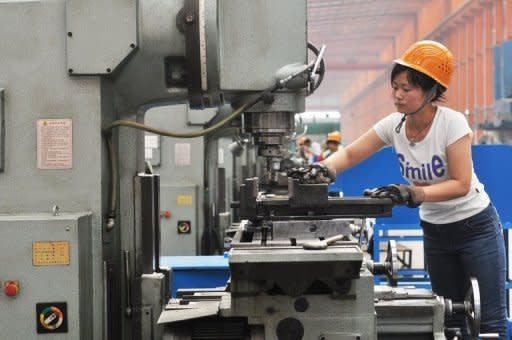 A woman works a machine at a factory in Binzhou, northeast China's Shandong province in June 2012. Preliminary figures from HSBC's closely watched purchasing managers' index (PMI), which gauges nationwide manufacturing activity, hit 47.8 this month, the lowest since November