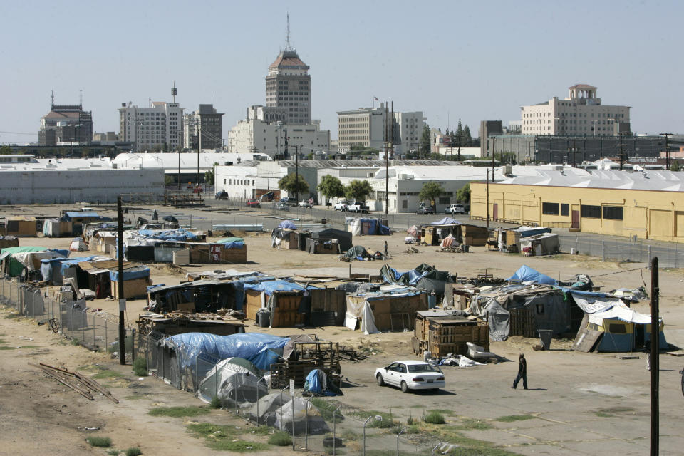 FILE - In this photo taken Thursday, June 18, 2009, one of three homeless encampments, known as tent city is seen in Fresno, Calif. Fresno. Nearly $200 million in grant money will go to California cities and counties to move homeless people from encampments into housing, California Gov. Gavin Newsom announced Thursday, April 18, 2024, pledging increased oversight of efforts by local governments to reduce homelessness. (AP Photo/Rich Pedroncelli, File)