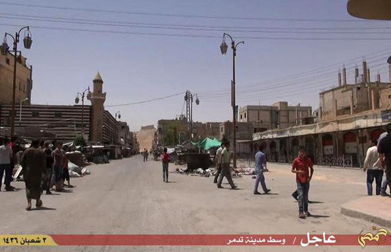 An image grab taken from a video made available by Jihadist media outlet Welayat Homs on May 21, 2015 allegedly shows people walking in a street of Syria's ancient city of Palmyra after the Islamic State (IS) group's jihadists seized it