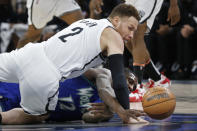 Brooklyn Nets center Blake Griffin (2) and Minnesota Timberwolves forward Taurean Prince vie for the ball in the second quarter of an NBA basketball game Sunday, Jan. 23, 2022, in Minneapolis. (AP Photo/Bruce Kluckhohn)