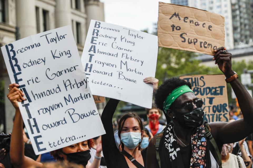 Protesters gather at an encampment outside City Hall, Tuesday, June 30, 2020, in New York. New York City lawmakers are holding a high-stakes debate on the city budget as activists demand a $1 billion shift from policing to social services and the city grapples with multibillion-dollar losses because of the coronavirus pandemic. (AP Photo/John Minchillo)