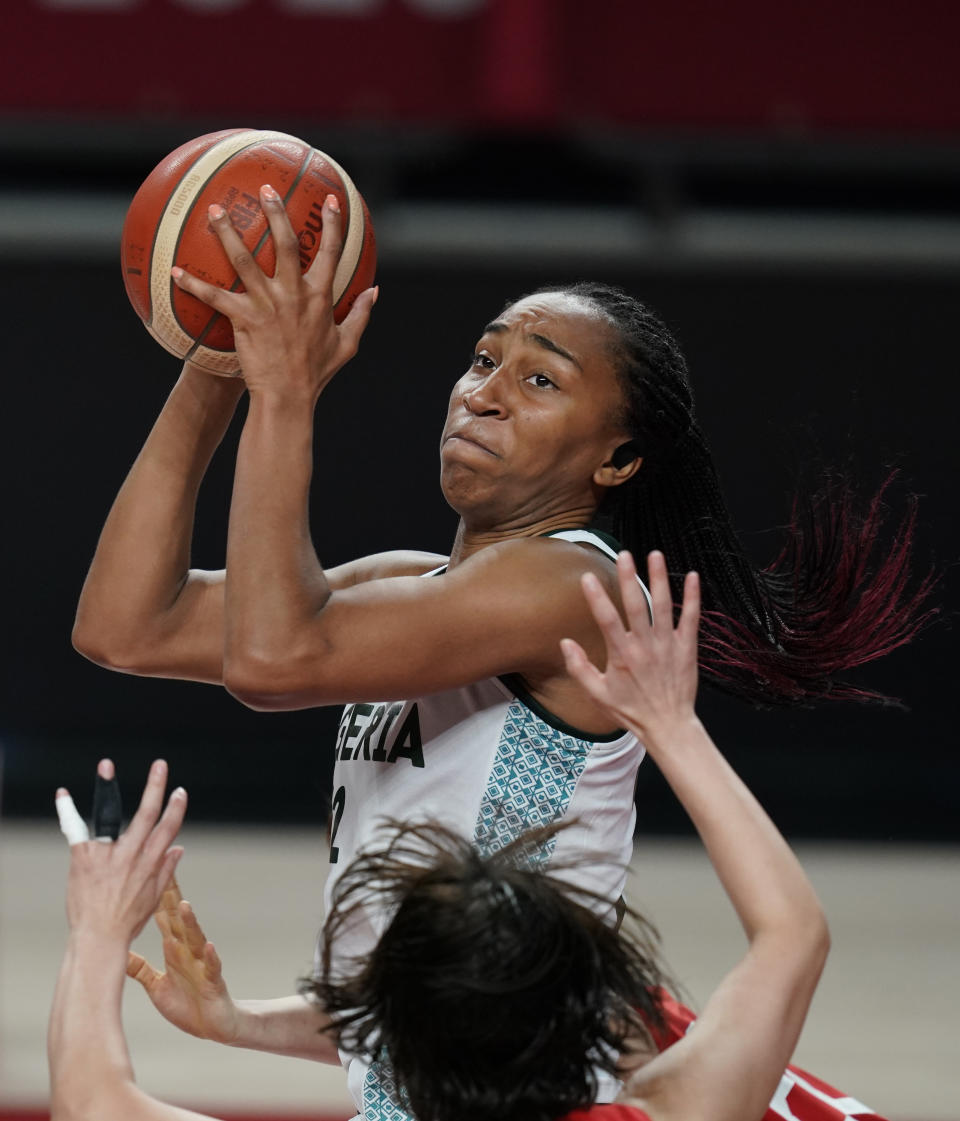 Nigeria's Oderah Chidom (22) shoots over Japan's Naho Miyoshi (12) during women's basketball preliminary round game at the 2020 Summer Olympics, Monday, Aug. 2, 2021, in Saitama, Japan. (AP Photo/Charlie Neibergall)