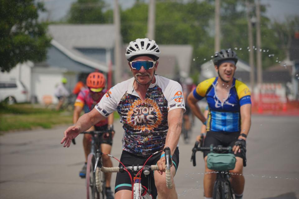 Riders get sprayed with water as they roll into Newton as RAGBRAI 50 rolls toward Tama-Toledo on Day 5 of the ride Thursday.