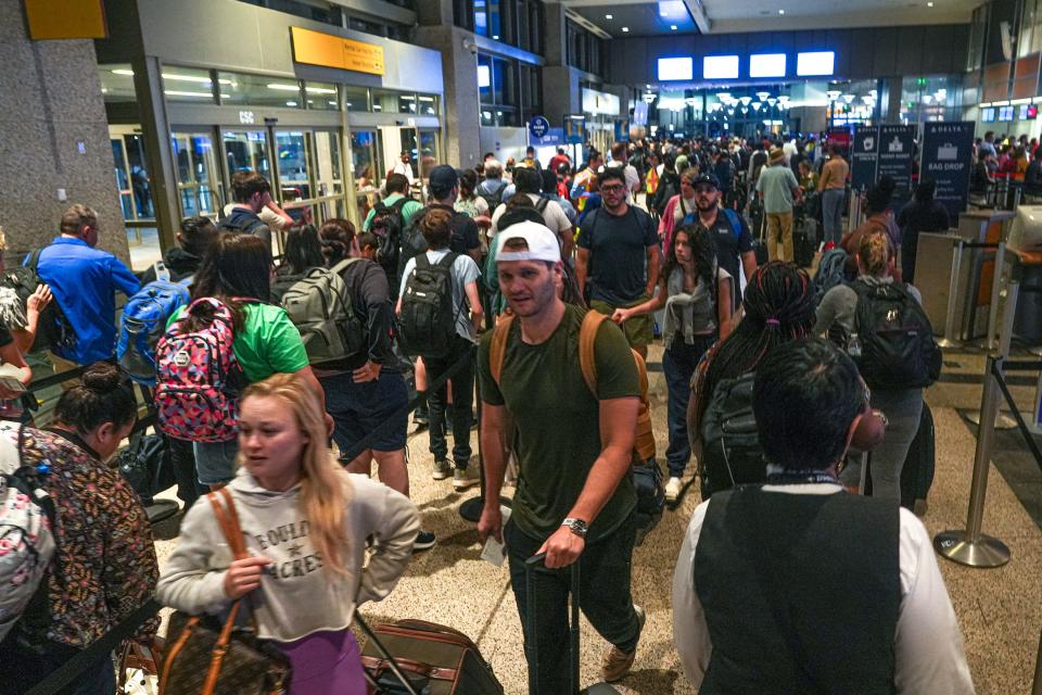 Travelers rush to ticket counters and navigate crowded security lines at Austin-Bergstrom International Airport on Thursday, June 29, 2023 in Austin.