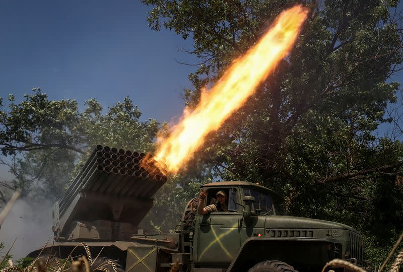 FILE PHOTO: Ukrainian servicemen fire a BM-21 Grad multiple launch rocket system towards Russian troops in Donetsk region