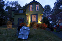 This 2017 photo released by Charles Fremont shows a home decorated for Halloween in Webster Groves, Mo. On a typical Halloween in the St. Louis suburb, neighbors go all out to decorate their houses and yards with spooky skeletons, tombstones and jack-o'-lanterns as up to 1,000 people pack the blocked-off street to carry on an old tradition: Tell a joke, get a treat. This Halloween is going to be vastly different for many. Parents and governments are weighing whether door-to-door trick-or-treating can safely happen. (Charles Fremont via AP)