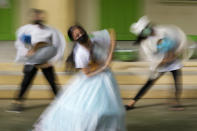 Abegail Mesa, center, dances with members of the INDAK Banak Dance Company in Taytay, Rizal province, Philippines on Tuesday, Sept. 28, 2021, as they practice their routine for an upcoming virtual dance competition next month. The group practices at open spaces wearing face masks and in small groups to adhere to health restrictions in their area. Mesa said that she had to stop dancing during the lockdown because of restrictions. She feels overwhelmed now since she can bond with friends and continue dancing. (AP Photo/Aaron Favila)