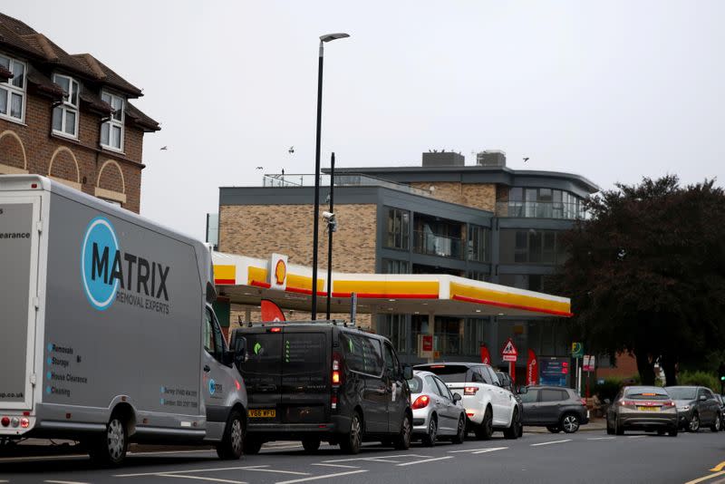 Vehicles queue to refill outside a fuel station in South London