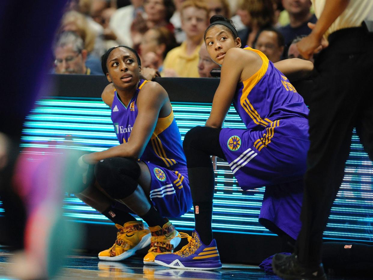 Candace Parker (right) and Nneka Ogwumike wait to check into a 2016 WNBA game for the Los Angeles Sparks.