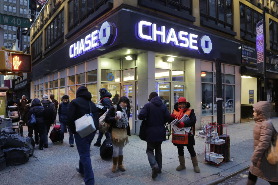People walk past a branch of Chase bank, in New York. JPMorgan Chase & Co. reports earnings, Friday, Jan. 12, 2018. (AP Photo/Mark Lennihan)