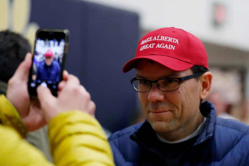 FILE PHOTO: A man gets his photo taken with his new "Make Alberta Great Again" hat while attending a rally for Wexit Alberta, a separatist group seeking federal political party status, in Calgary