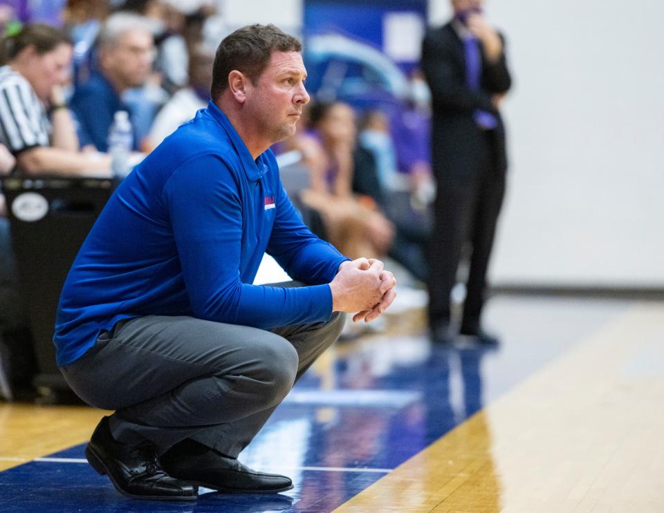 Roncalli High School head coach Jason Sims watches the action on the court during the first half of an IHSAA Girls’ Sectional semi-final basketball game against Ben Davis High School, Friday, Feb. 4, 2022, at Perry Meridian High School.
