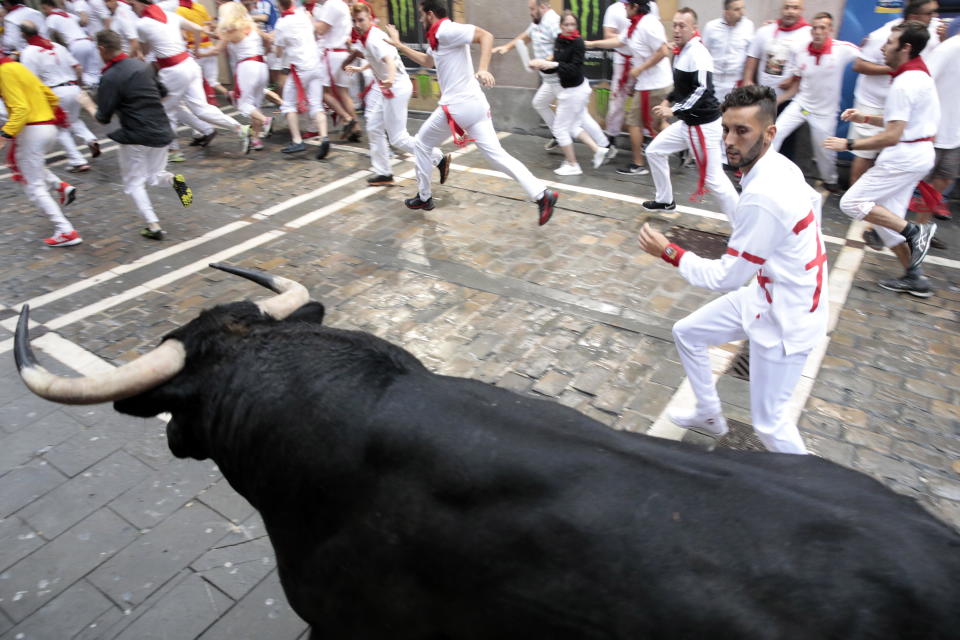 A fighting bull from the ranch of Puerto de San Lorenzo stampedes around a corner in the first ‘encierro’ or running-with-the-bulls during the Festival of San Fermin 2018 in Pamplona, Spain (EPA)