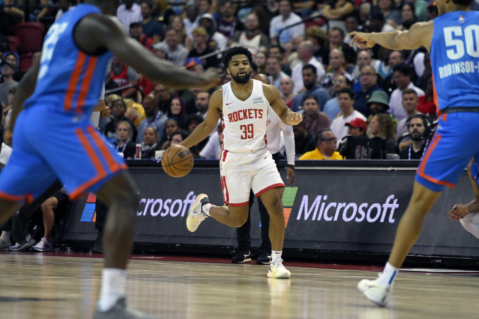 Houston Rockets' Trevor Hudgins (39) brings the ball up against the Oklahoma City Thunder during the first half of an NBA summer league basketball game Saturday, July 9, 2022, in Las Vegas. (AP Photo/David Becker)