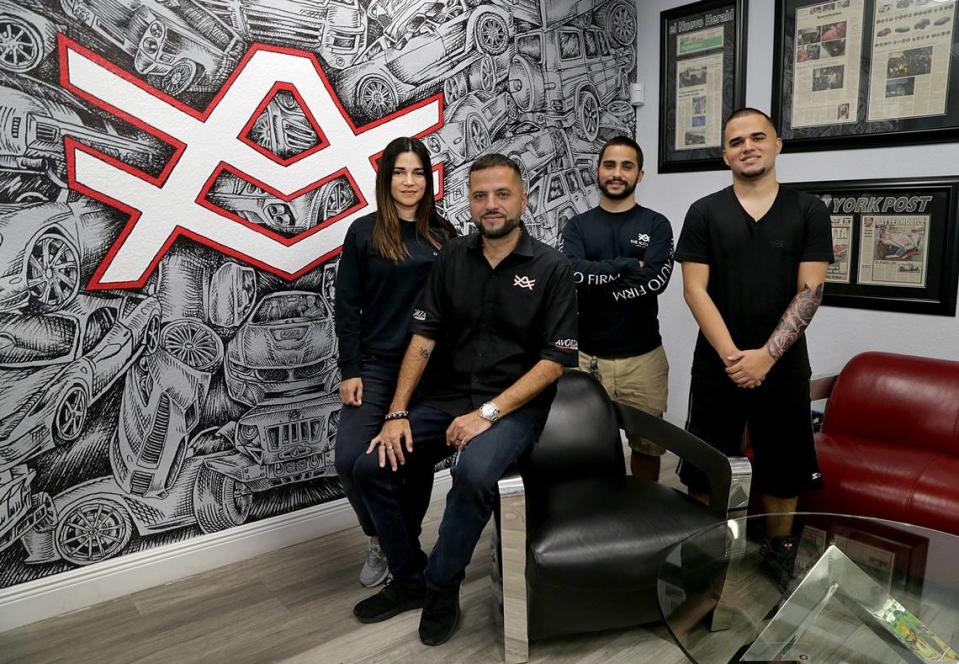 In a 2018 MIami Herald photo, Alex Vega and his wife Aymara Vega, owners of The Auto Firm, are shown with their sons Alex Jr. and Adriel Vega, far right, in their shop in Kendall.