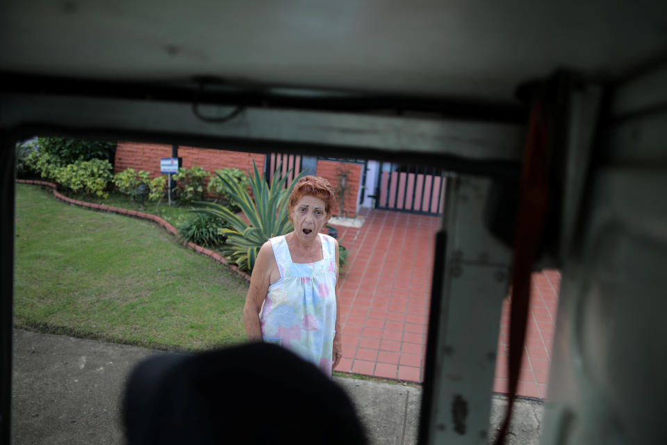 <p>A local resident reacts as a mail man from the U.S. Postal Service arrives at her house at an area affected by Hurricane Maria in San Juan, Puerto Rico, Oct. 6, 2017. (Photo: Carlos Barria/Reuters) </p>