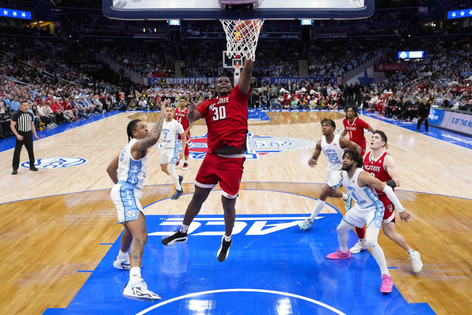 North Carolina State forward DJ Burns Jr. (30) scores against North Carolina during the first half of an NCAA college basketball game in the championship of the Atlantic Coast Conference tournament, Saturday, March 16, 2024, in Washington. North Carolina State won 84-76. (AP Photo/Alex Brandon)