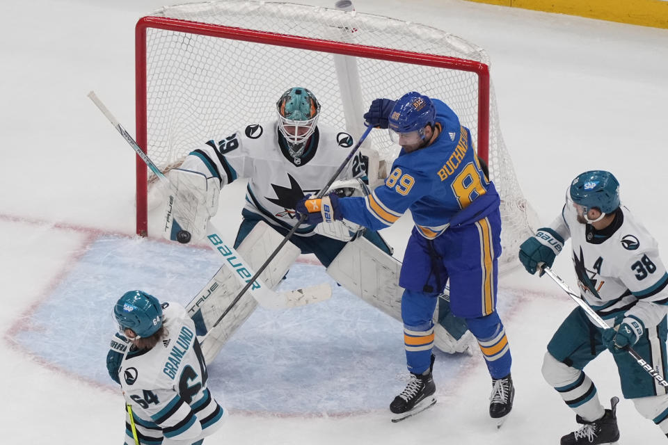 St. Louis Blues' Pavel Buchnevich (89) reaches for a loose puck as San Jose Sharks goaltender Mackenzie Blackwood (29) defends during the third period of an NHL hockey game Saturday, March 30, 2024, in St. Louis. (AP Photo/Jeff Roberson)
