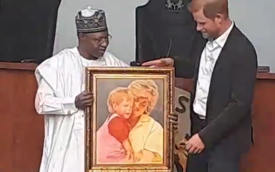 Prince Harry was presented with two portraits, one of which was of him and his mother, Princess Diana